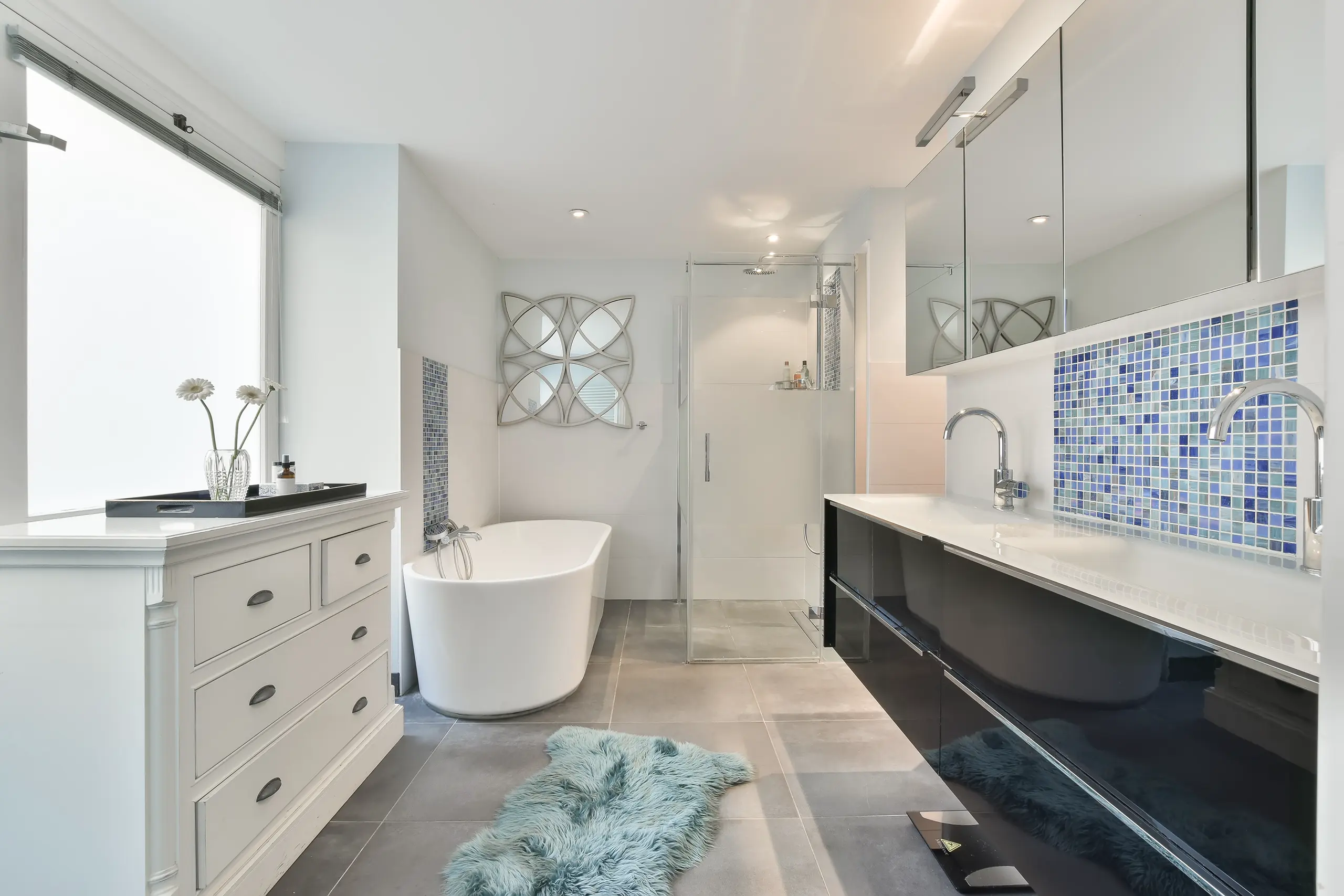 Modern bathroom with freestanding tub, frameless glass shower, dual vanity and blue mosaic tile backsplash – Bathroom Remodeling