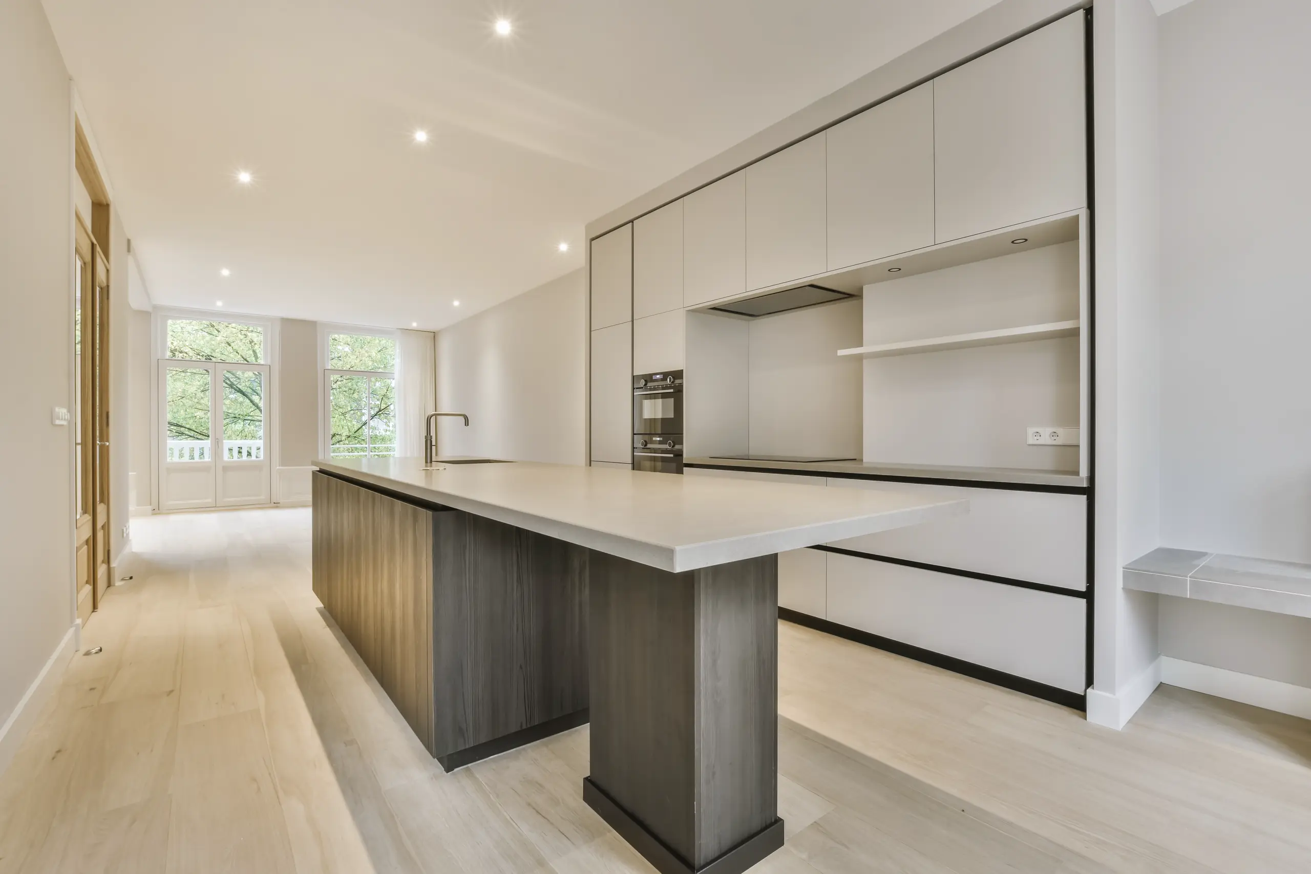 Bright modern open kitchen with large island and sleek cabinetry after Custom Kitchen Remodel