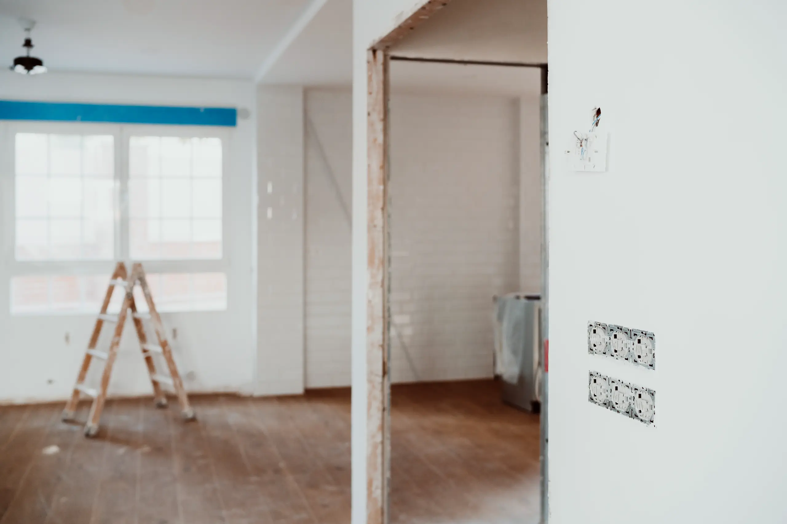 Interior space with exposed studs, removed outlets and ladder during Wall Removal
