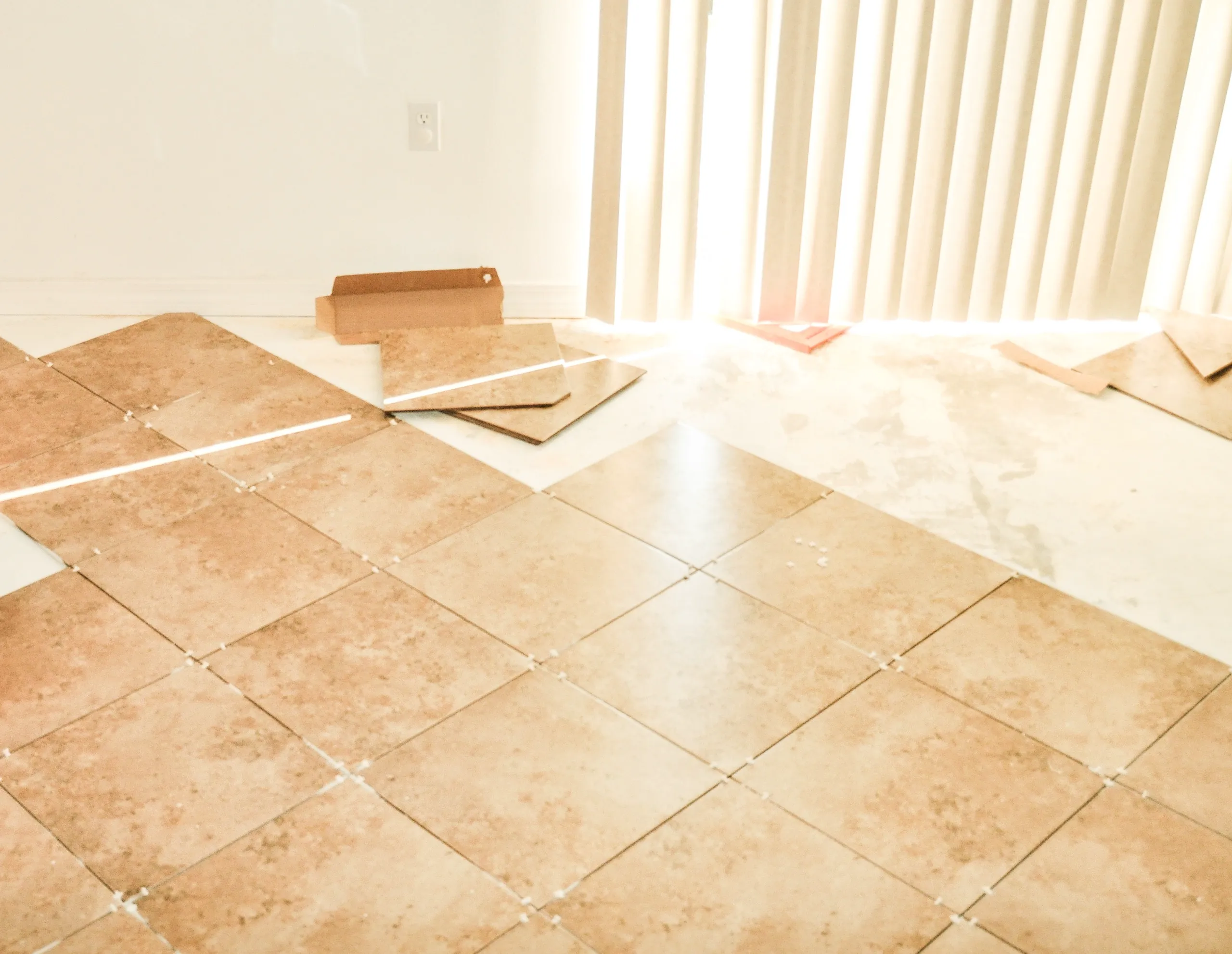 Partial floor tile installation with spacers visible – Tile Work