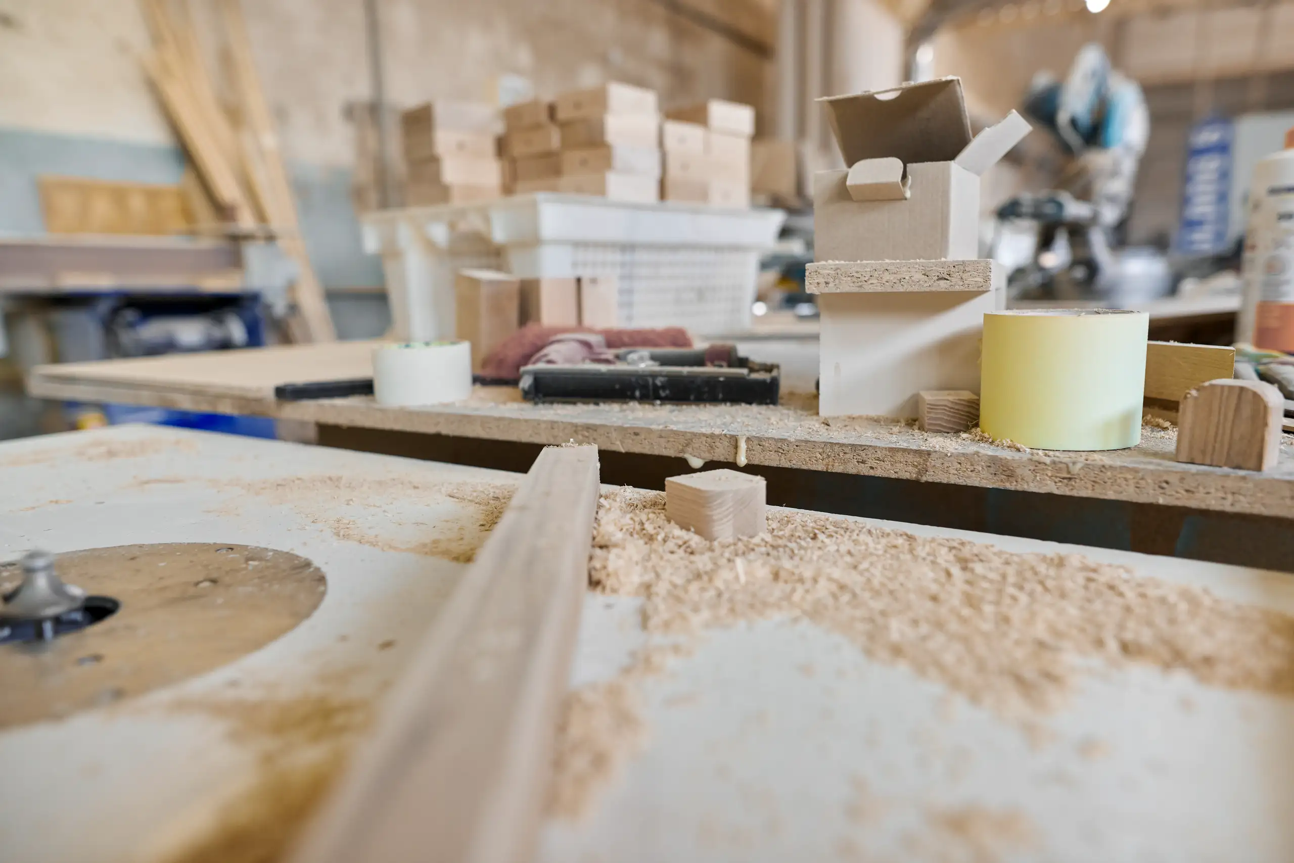 Router table with wood shavings, wooden blocks and tools for Fine Carpentry